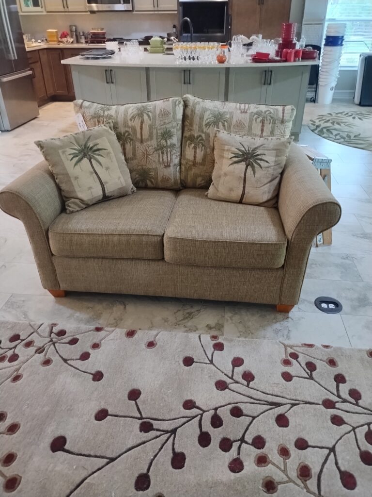 Loveseat and cushions left after estate sale awaiting removal or donation in Central Florida