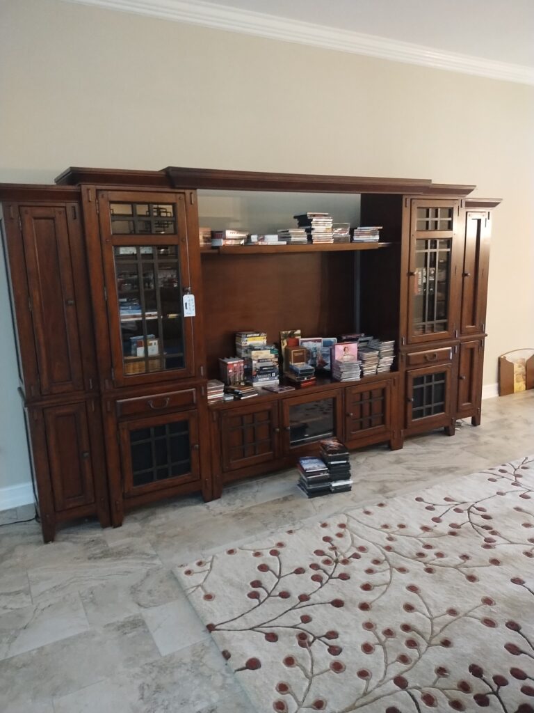 Unsold wall unit from estate sale awaiting removal in Homosassa Springs Florida home